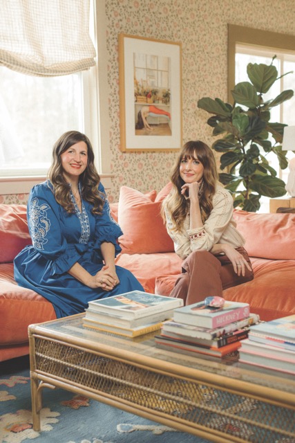 Gray Benko and Chelcie Eastman seated on a pink sofa in Gray's colorful Lowcountry living room, featured in Azalea Magazine's Living Fully At Home feature
