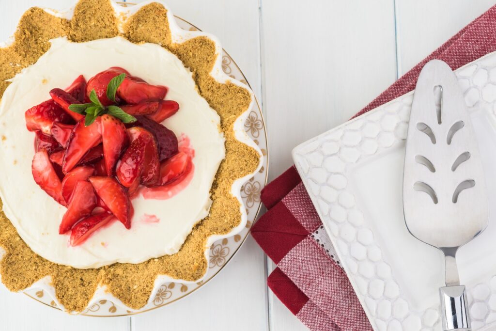 Strawberry pretzel icebox pie topped with fresh strawberries and whipped cream