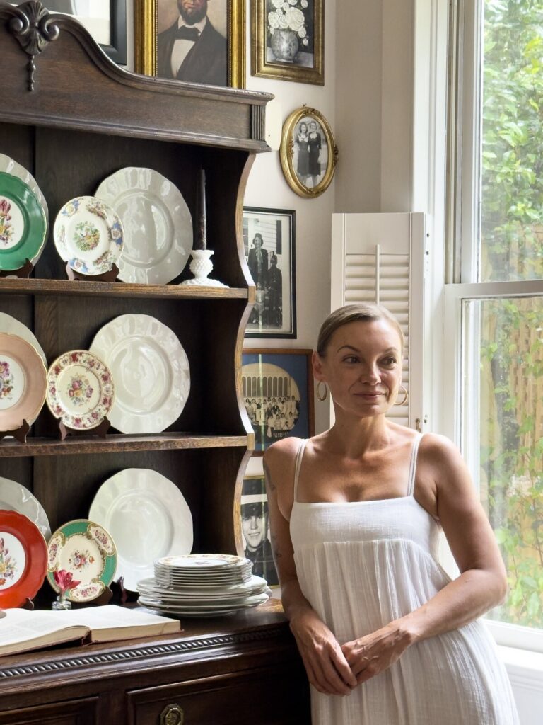 Erin Carlson beside the Welsh dresser at the kitchen window