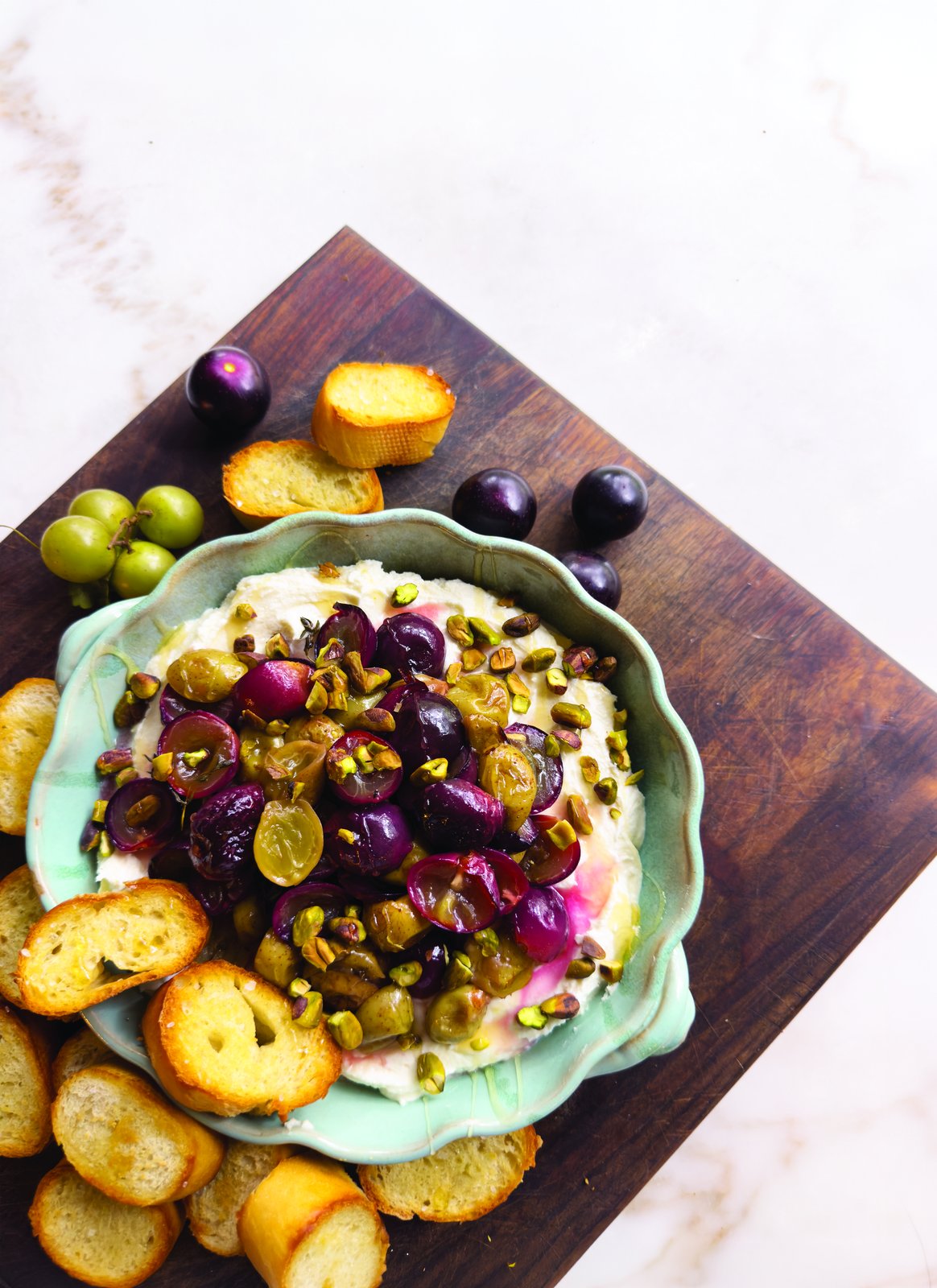 Roasted muscadines over whipped goat cheese with crostini